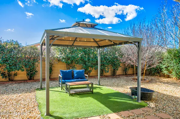 a view of a chair and tables in the patio