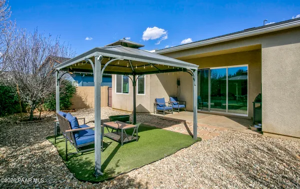 a backyard of a house with table and chairs