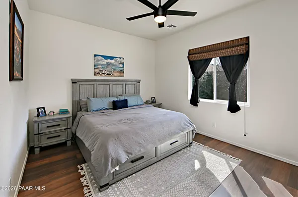 a bedroom with a bed and a painting on the wall