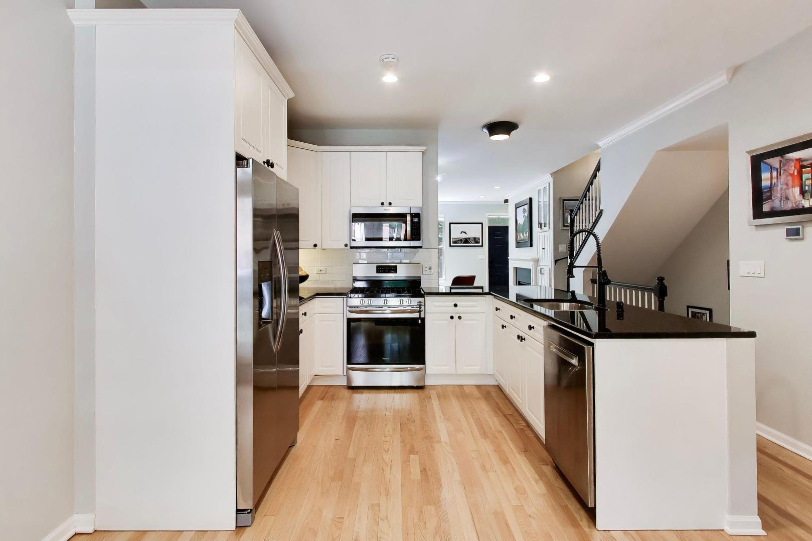 232 West Scott Street Chicago, IL 60610 - Photo 6 of 39 a kitchen with stainless steel appliances a refrigerator a stove top oven and white walls