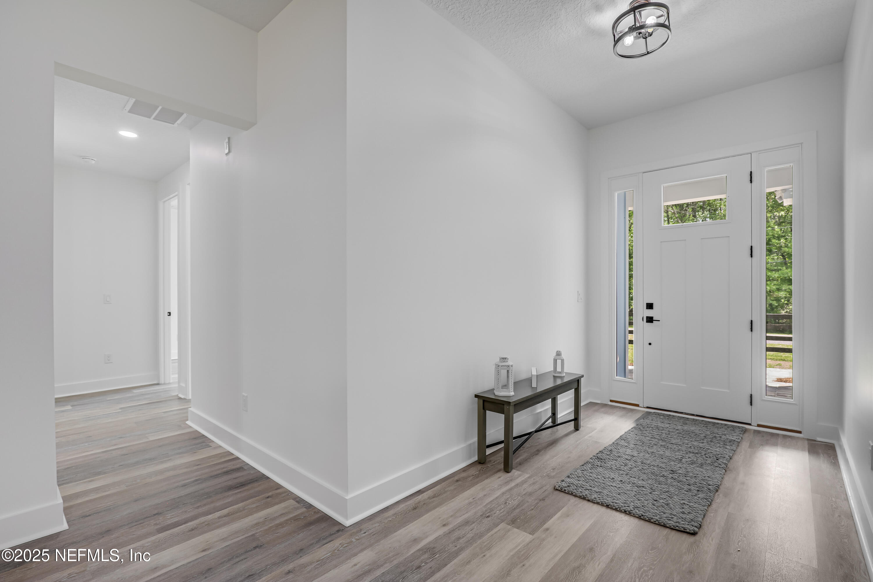 12092 Sheffield Road Jacksonville, FL 32226 - Photo 11 of 55 an empty room with wooden floor and windows