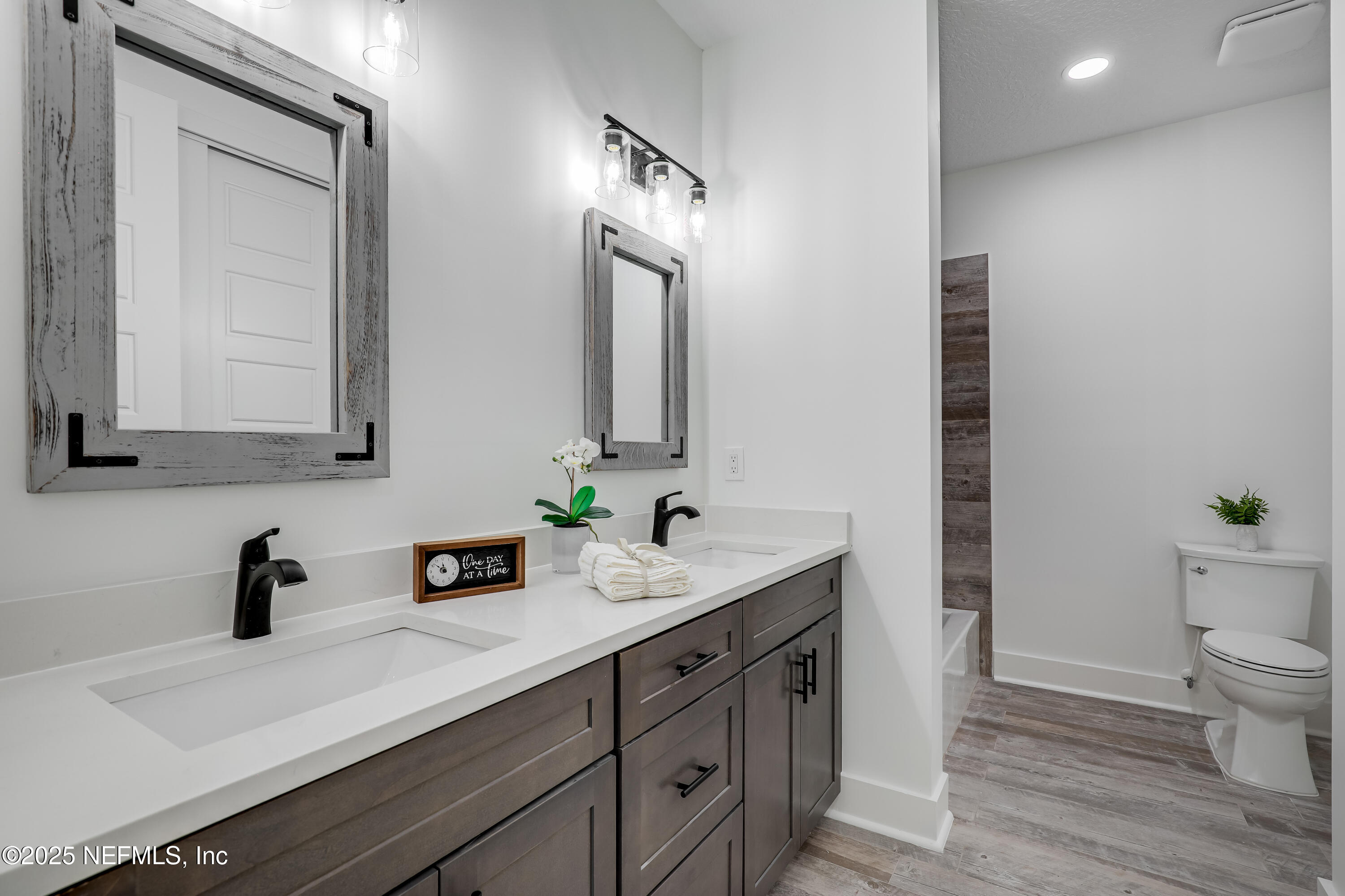 12092 Sheffield Road Jacksonville, FL 32226 - Photo 12 of 55 a bathroom with a double vanity sink and a mirror