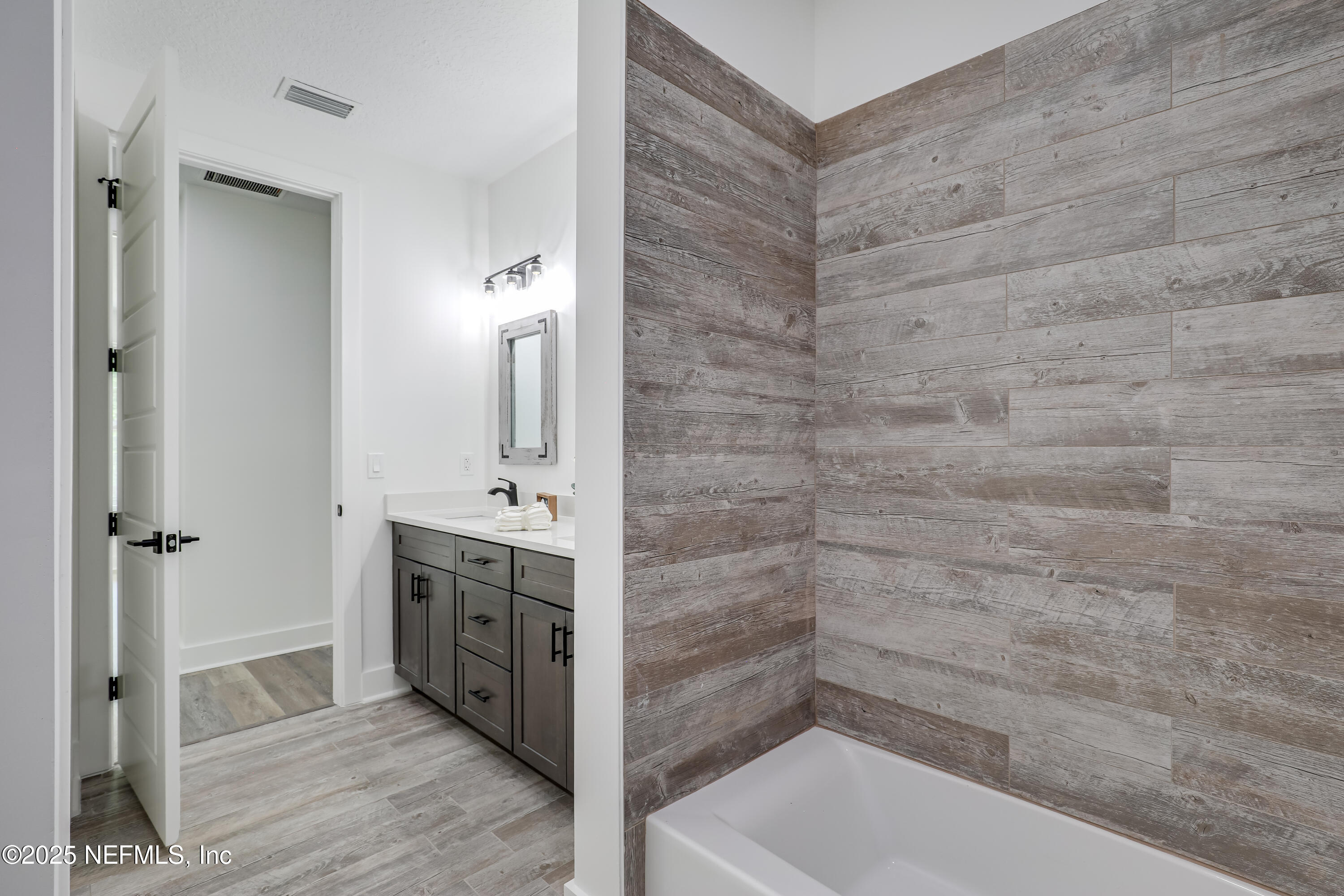 12092 Sheffield Road Jacksonville, FL 32226 - Photo 13 of 55 a bathroom with a sink and a mirror
