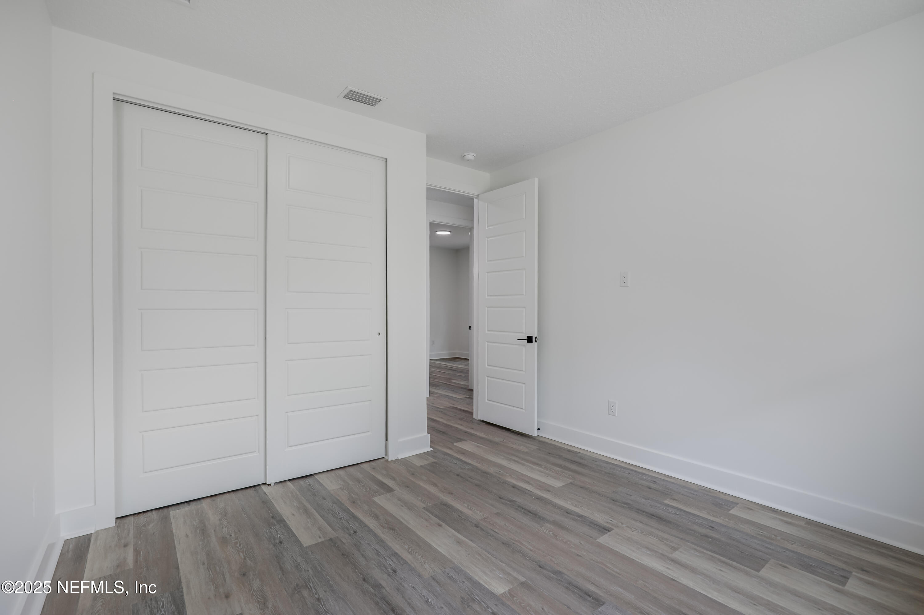 12092 Sheffield Road Jacksonville, FL 32226 - Photo 15 of 55 a view of an empty room and wooden floor