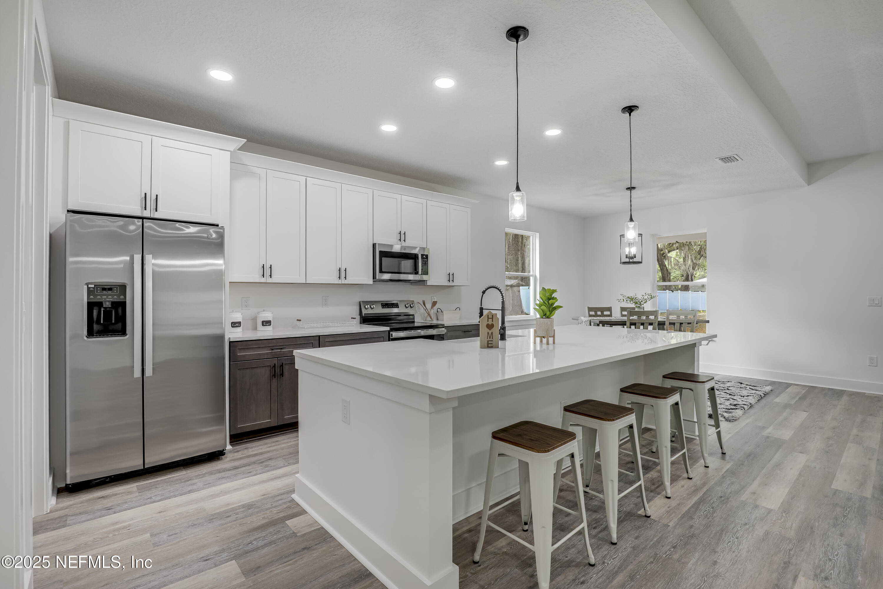 12092 Sheffield Road Jacksonville, FL 32226 - Photo 24 of 55 a kitchen with kitchen island white cabinets and stainless steel appliances