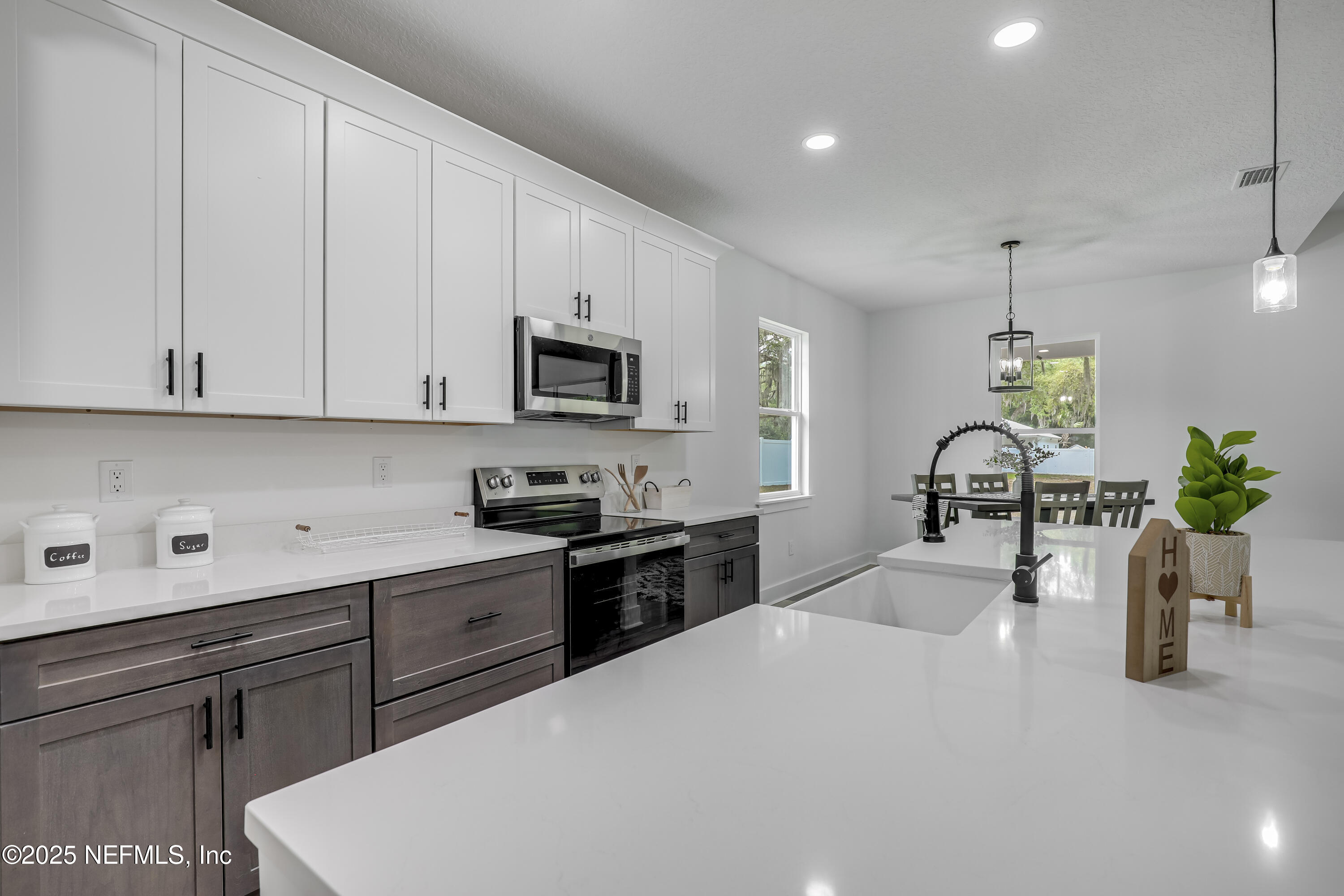 12092 Sheffield Road Jacksonville, FL 32226 - Photo 25 of 55 a kitchen with a sink stainless steel appliances and white cabinets