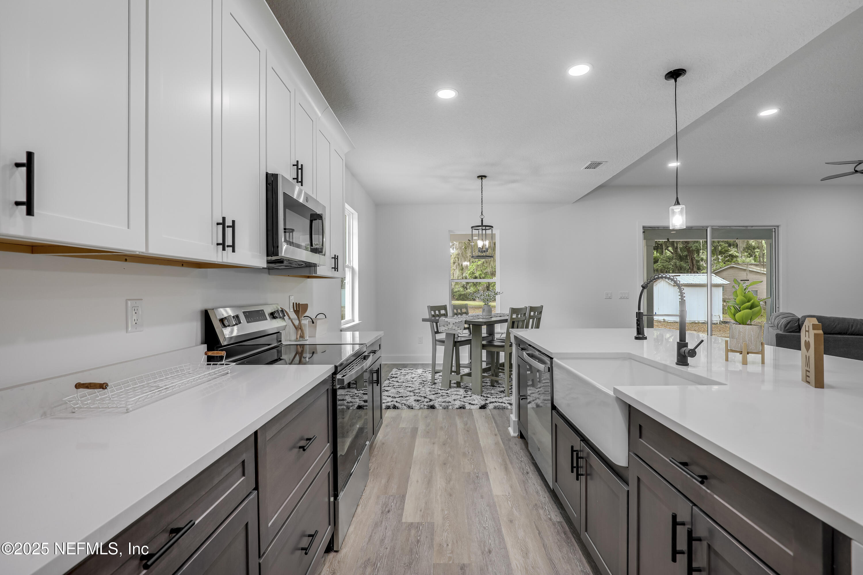 12092 Sheffield Road Jacksonville, FL 32226 - Photo 26 of 55 a kitchen with lots of counter space a sink appliances and cabinets