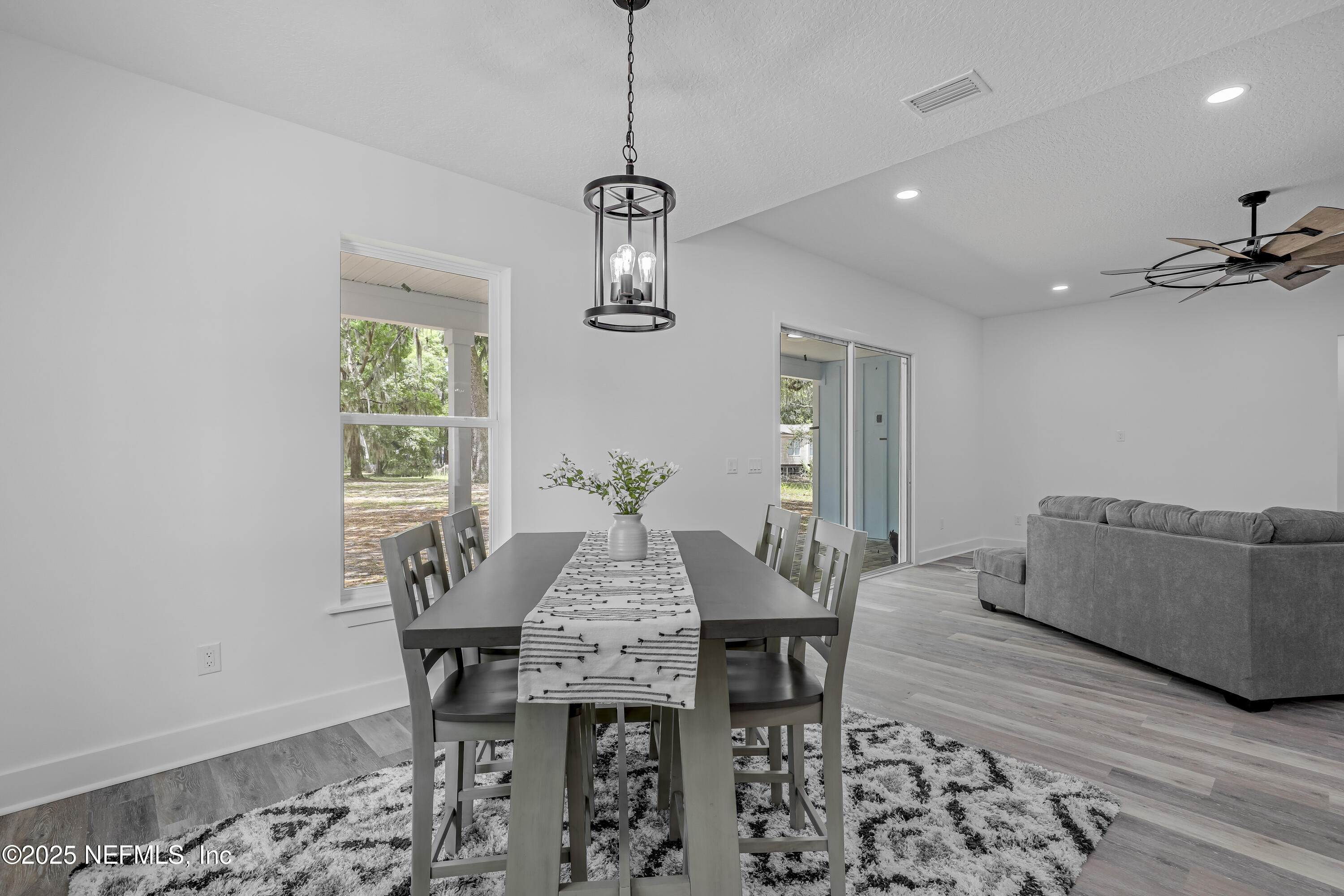 12092 Sheffield Road Jacksonville, FL 32226 - Photo 29 of 55 a view of a dining room with furniture window and wooden floor