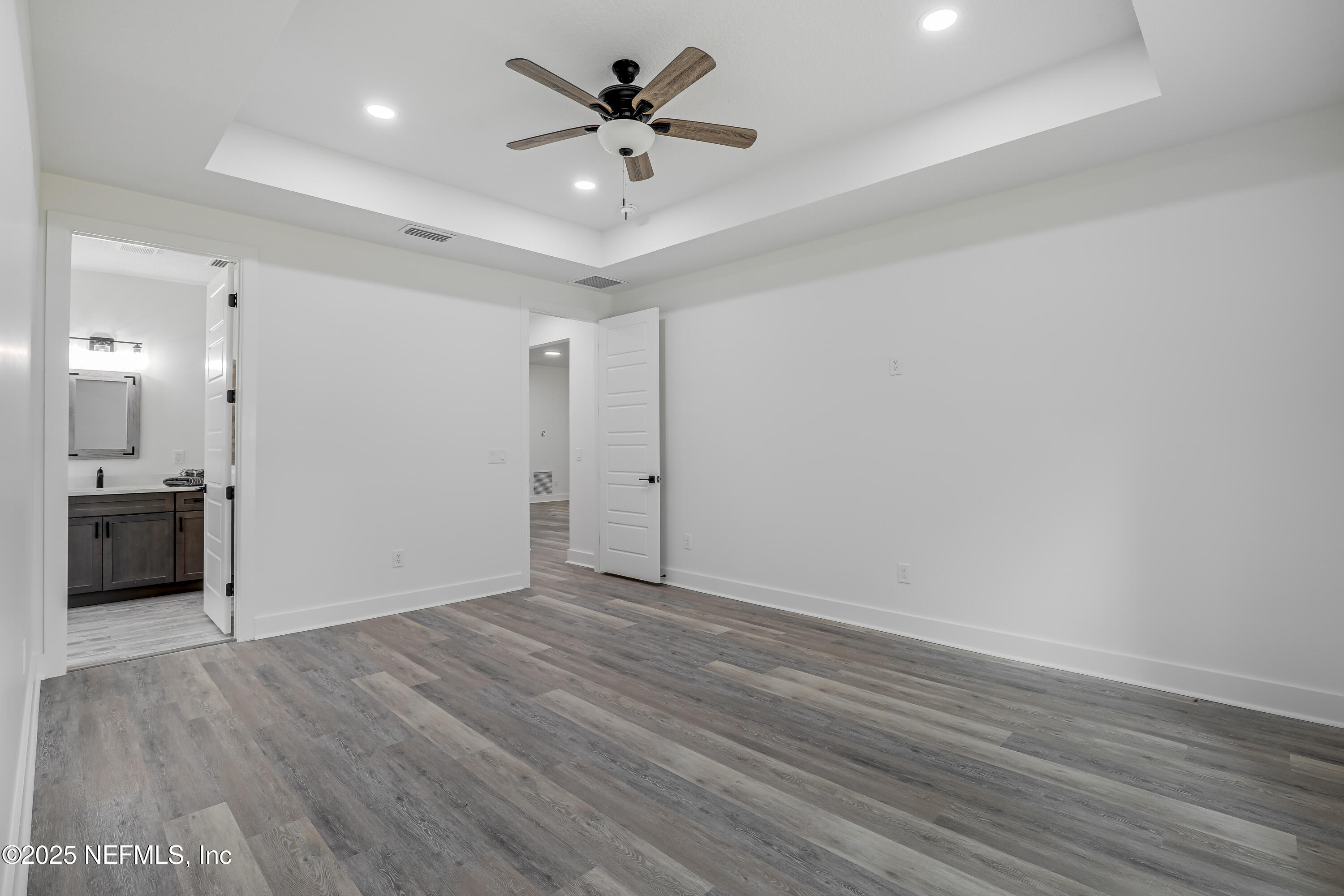12092 Sheffield Road Jacksonville, FL 32226 - Photo 35 of 55 a view of a big room with wooden floor and a ceiling fan