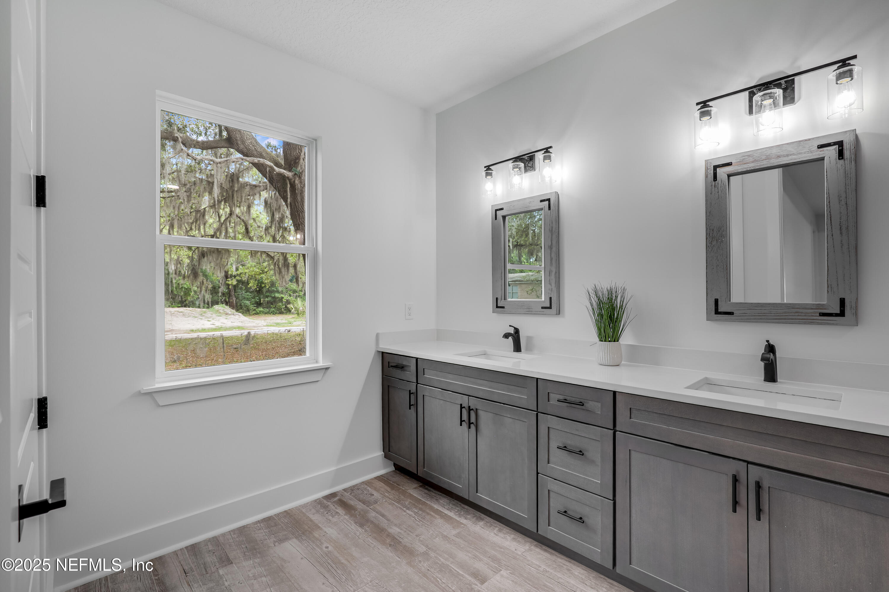 12092 Sheffield Road Jacksonville, FL 32226 - Photo 37 of 55 a bathroom with a double vanity sink and mirror with window