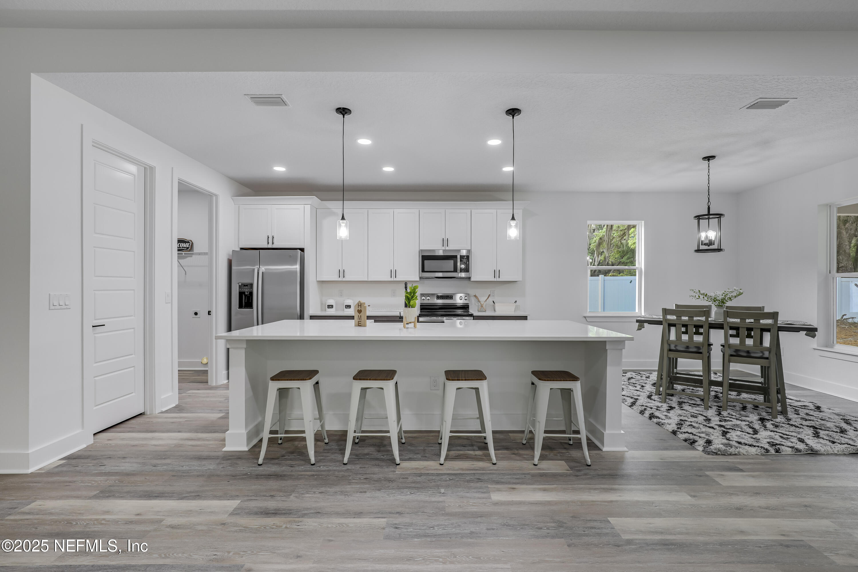 12092 Sheffield Road Jacksonville, FL 32226 - Photo 4 of 55 a kitchen with stainless steel appliances granite countertop a table chairs sink refrigerator and microwave