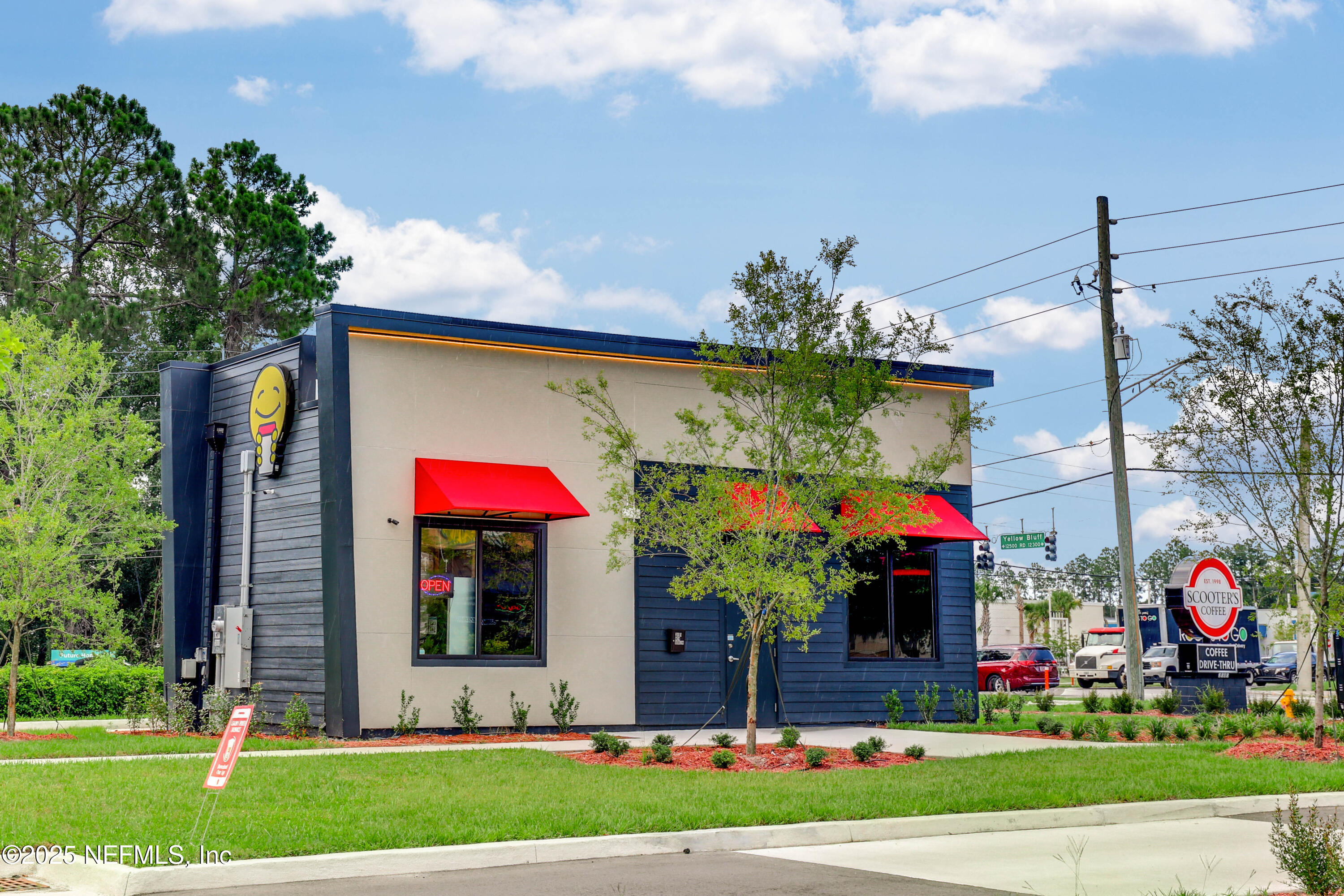12092 Sheffield Road Jacksonville, FL 32226 - Photo 49 of 55 a front view of a house with a yard and potted plants