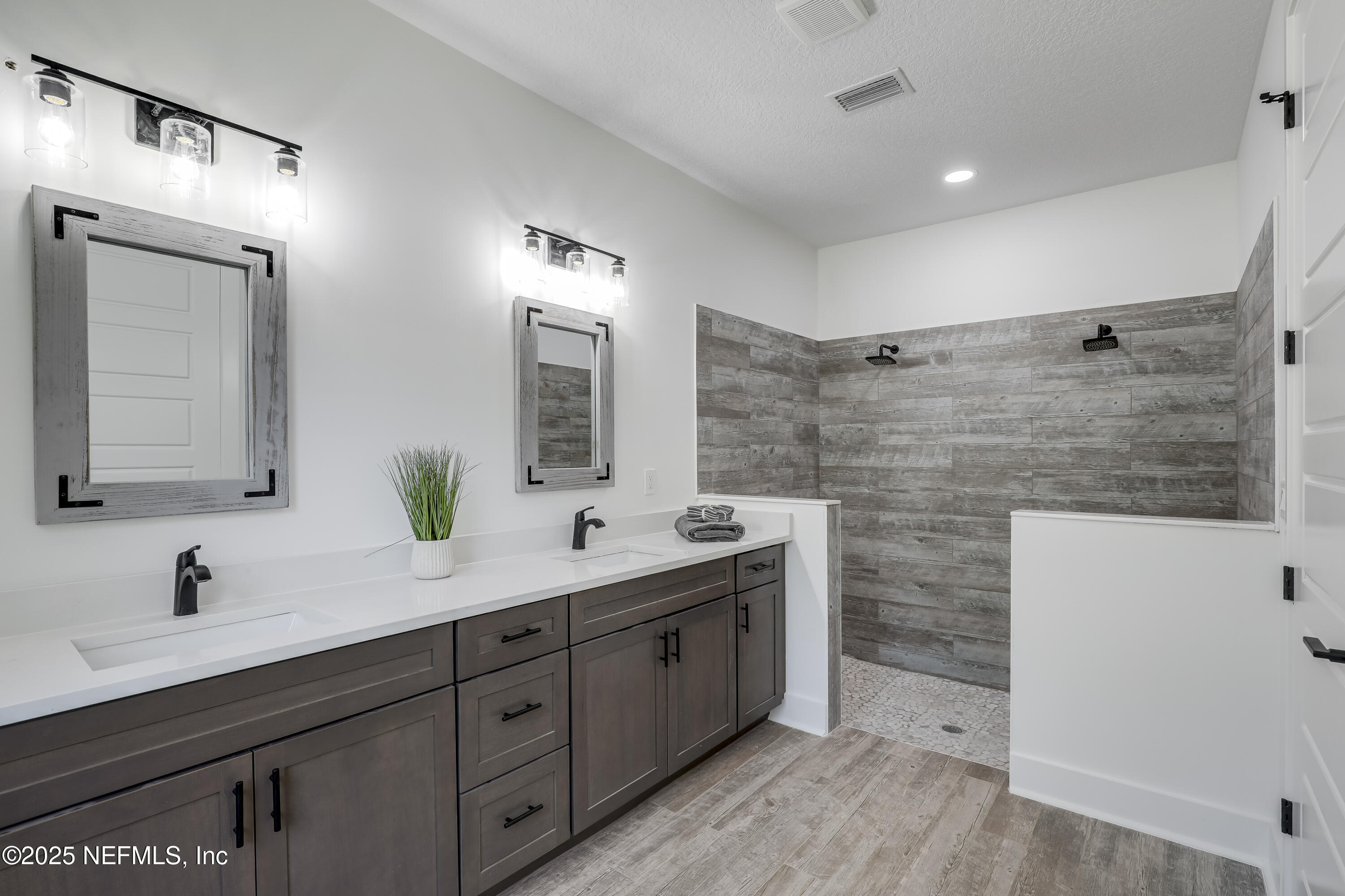 12092 Sheffield Road Jacksonville, FL 32226 - Photo 6 of 55 a spacious bathroom with a double vanity sink mirror and double