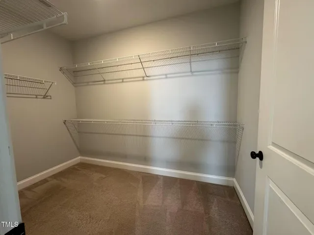 a empty room with racks on the wall