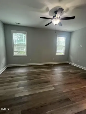a view of room with window and ceiling fan