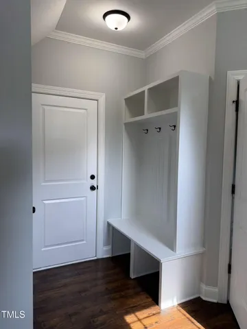 a view of an empty room with wooden floor