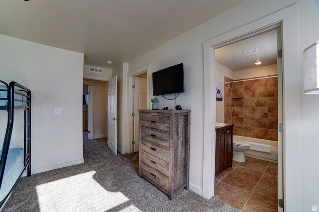 3853 South Red Valley Circle, Unit 22A1 Moab, UT 84532 - Photo 18 of 28 Bedroom with light colored carpet and connected bathroom