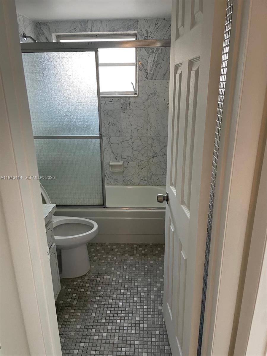 140 Royal Palm Road, Unit 211 Hialeah Gardens, FL 33016 - Photo 2 of 4 a bathroom with a toilet and a shower