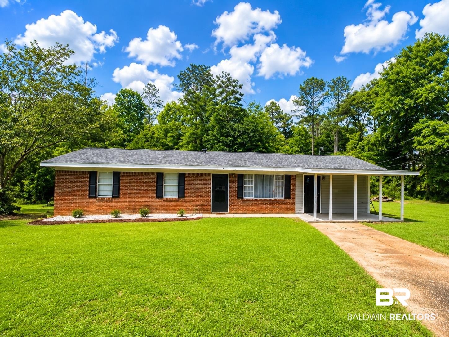 226 Elizabeth Street Evergreen, AL 36401 - Photo 1 of 35 Brick exterior with a dark shingle roof and black shutters