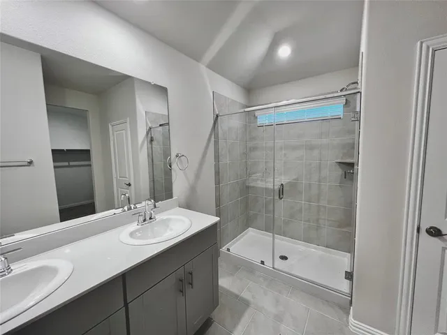 an empty room with a ceiling fan and window