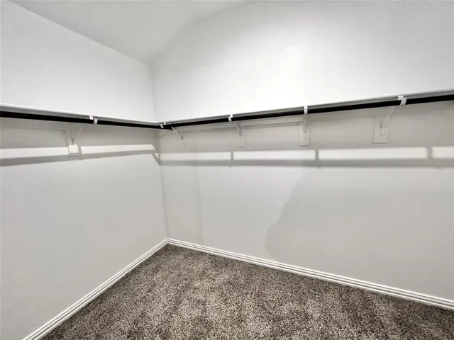 a white toilet sitting next to a shower