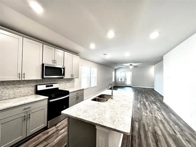 a view of a backyard with wooden fence