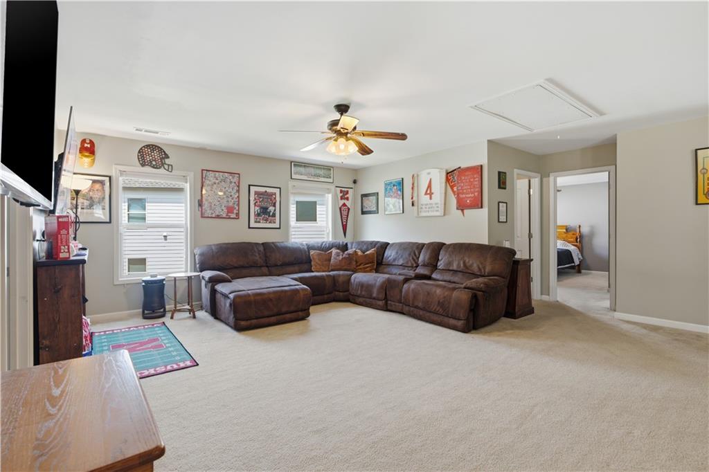 5825 Willow Oak Pass Cumming, GA 30040 - Photo 39 of 55 a living room with furniture and a flat screen tv
