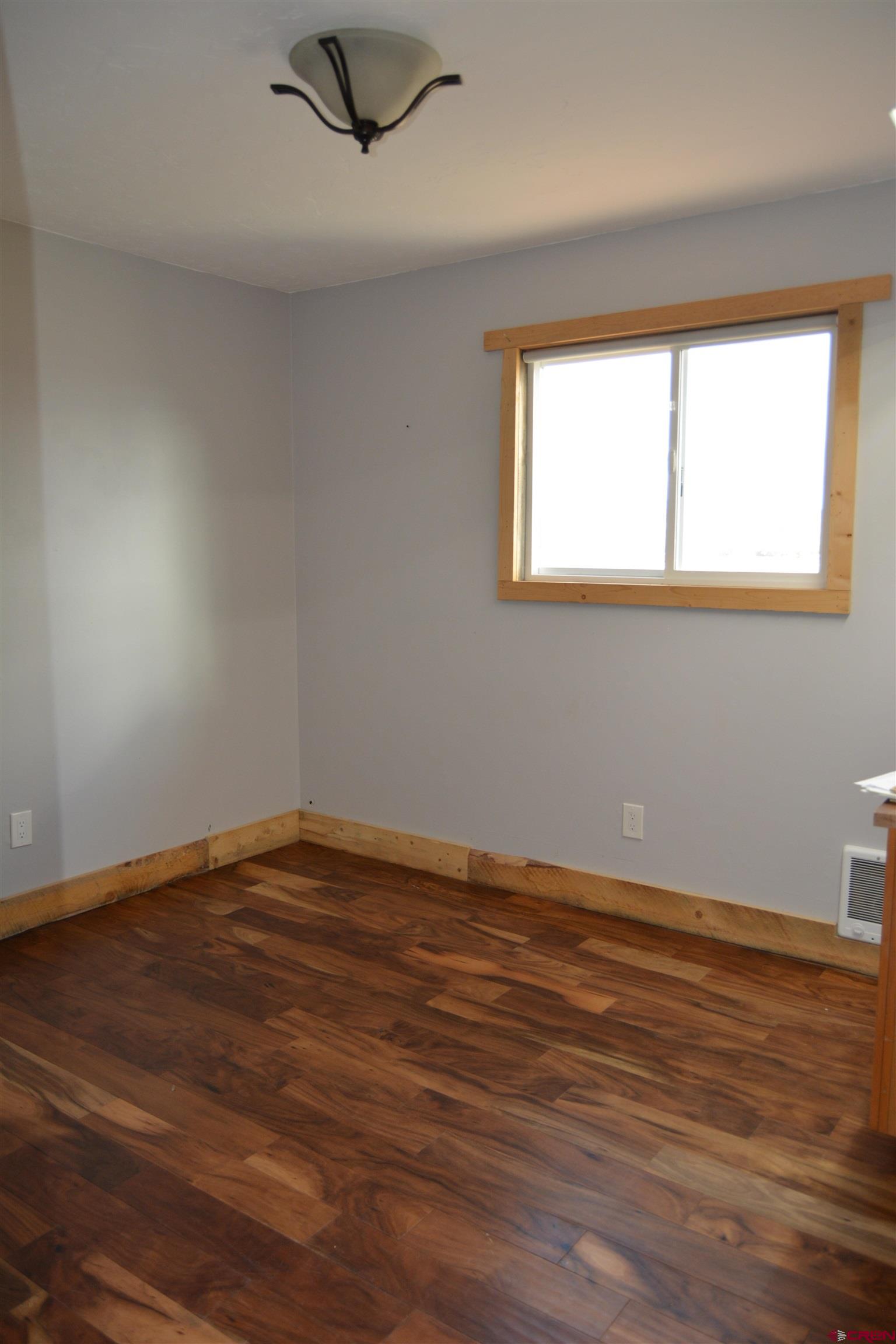 10053 2100th Road Austin, CO 81410 - Photo 16 of 41 a view of an empty room with wooden floor and a window
