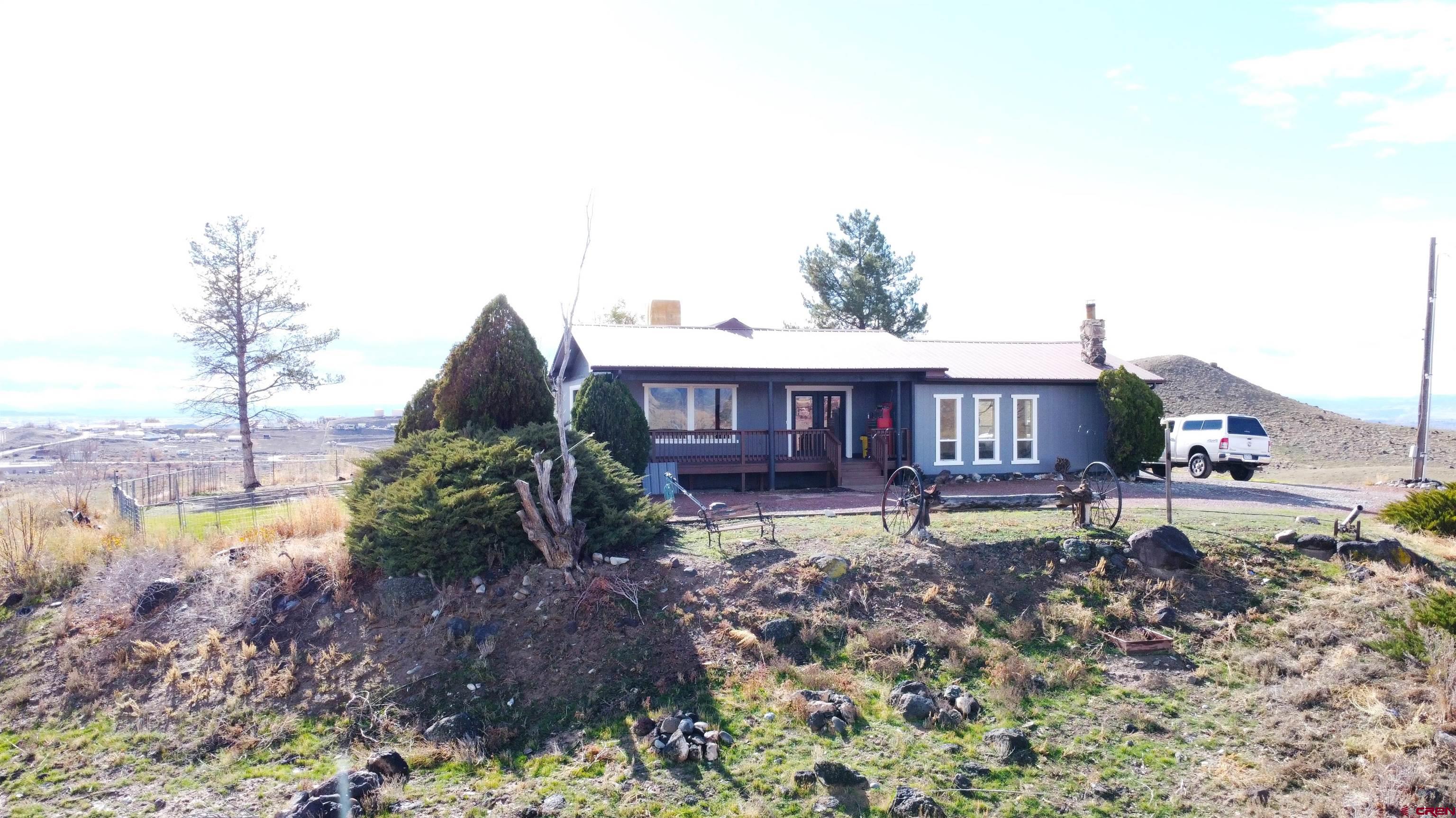 10053 2100th Road Austin, CO 81410 - Photo 4 of 41 a view of a house with a yard and sitting area