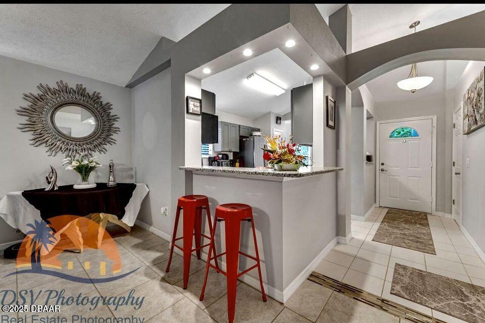 27 Reflections Village Drive Ormond Beach, FL 32174 - Photo 18 of 29 a living room with furniture a flat screen tv and a table