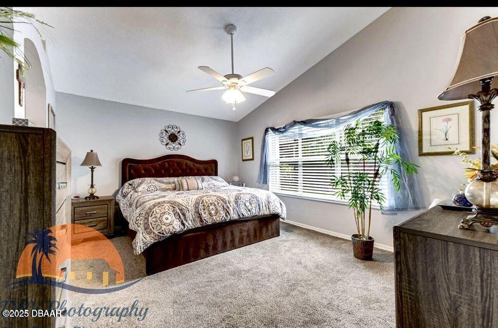 27 Reflections Village Drive Ormond Beach, FL 32174 - Photo 3 of 29 a spacious bedroom with a bed and a couch