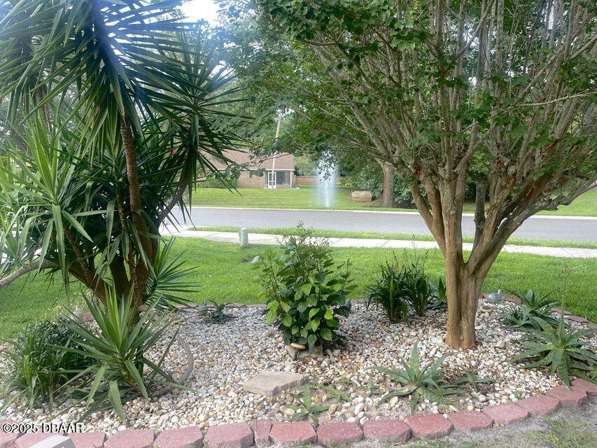 27 Reflections Village Drive Ormond Beach, FL 32174 - Photo 10 of 29 a view of a garden with trees
