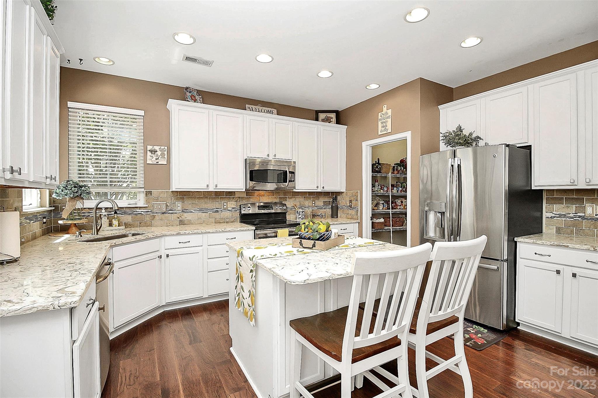 1958 Faison Avenue Fort Mill, SC 29708 - Photo 8 of 37 a kitchen with a table chairs sink refrigerator and microwave