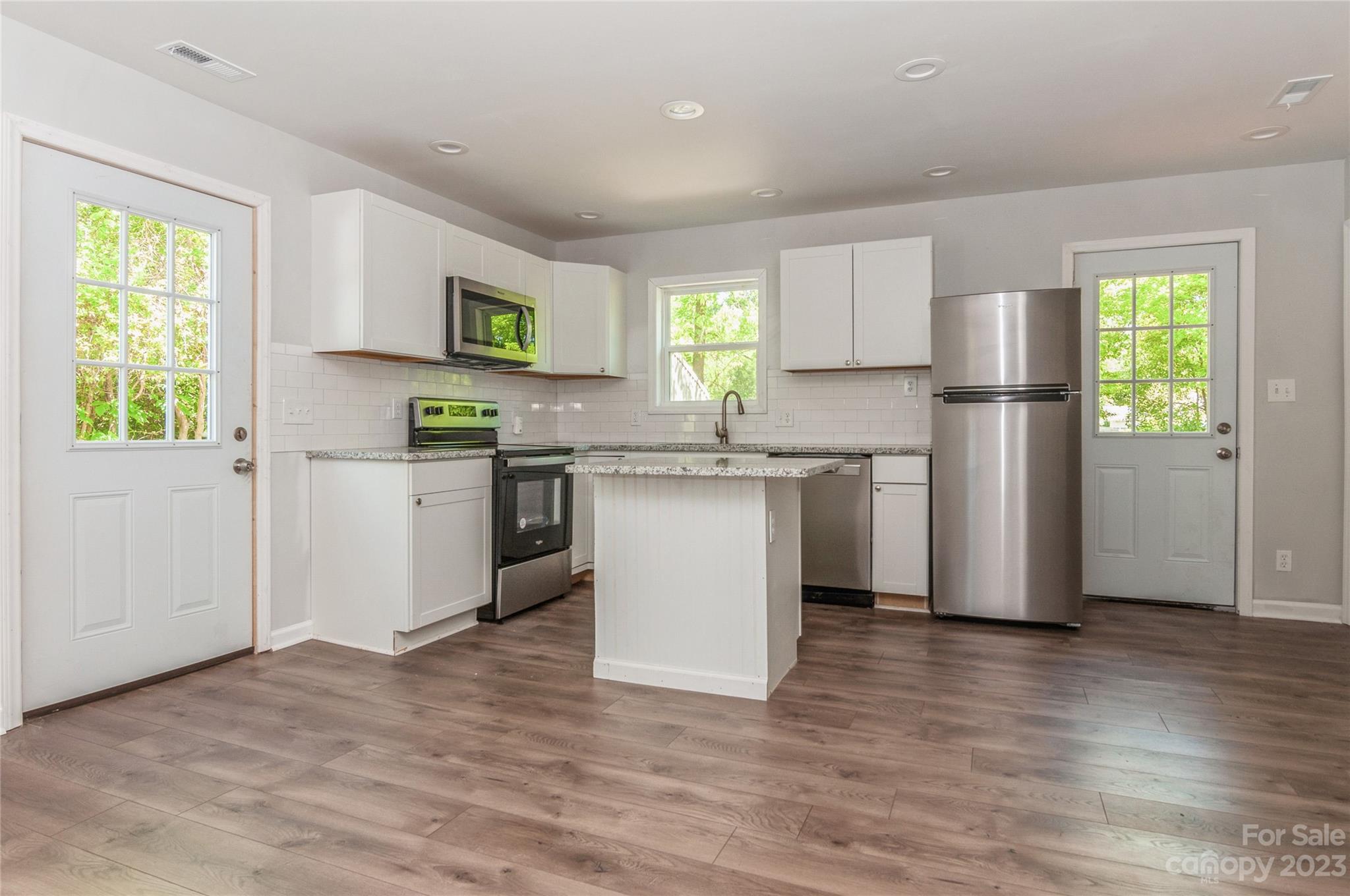 195 Porter Road Rock Hill, SC 29730 - Photo 8 of 27 a kitchen with stainless steel appliances granite countertop a refrigerator a sink a stove a microwave a counter space and cabinets