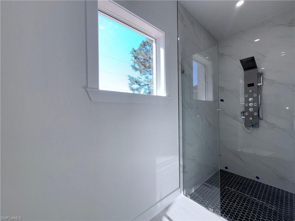 423 Harshaw Street Lehigh Acres, FL 33974 - Photo 17 of 27 a bathroom with a window