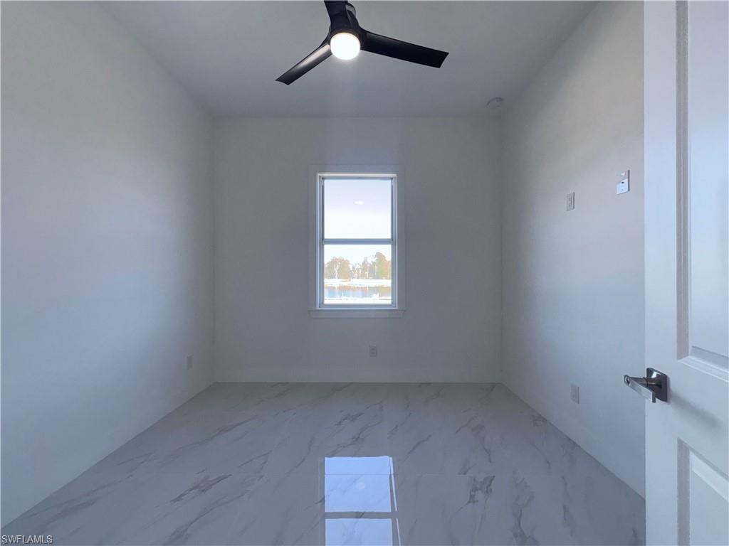 423 Harshaw Street Lehigh Acres, FL 33974 - Photo 18 of 27 an empty room with a window