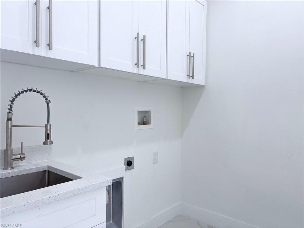 423 Harshaw Street Lehigh Acres, FL 33974 - Photo 20 of 27 a kitchen with a sink and cabinets