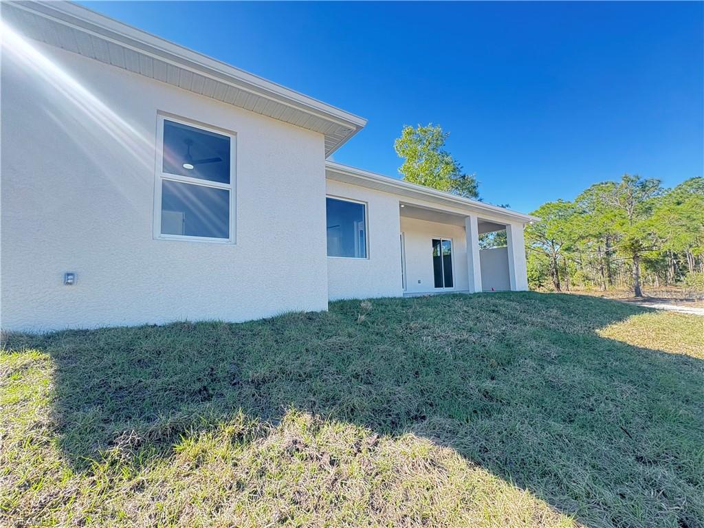 423 Harshaw Street Lehigh Acres, FL 33974 - Photo 24 of 27 a view of backyard with a garden and plants