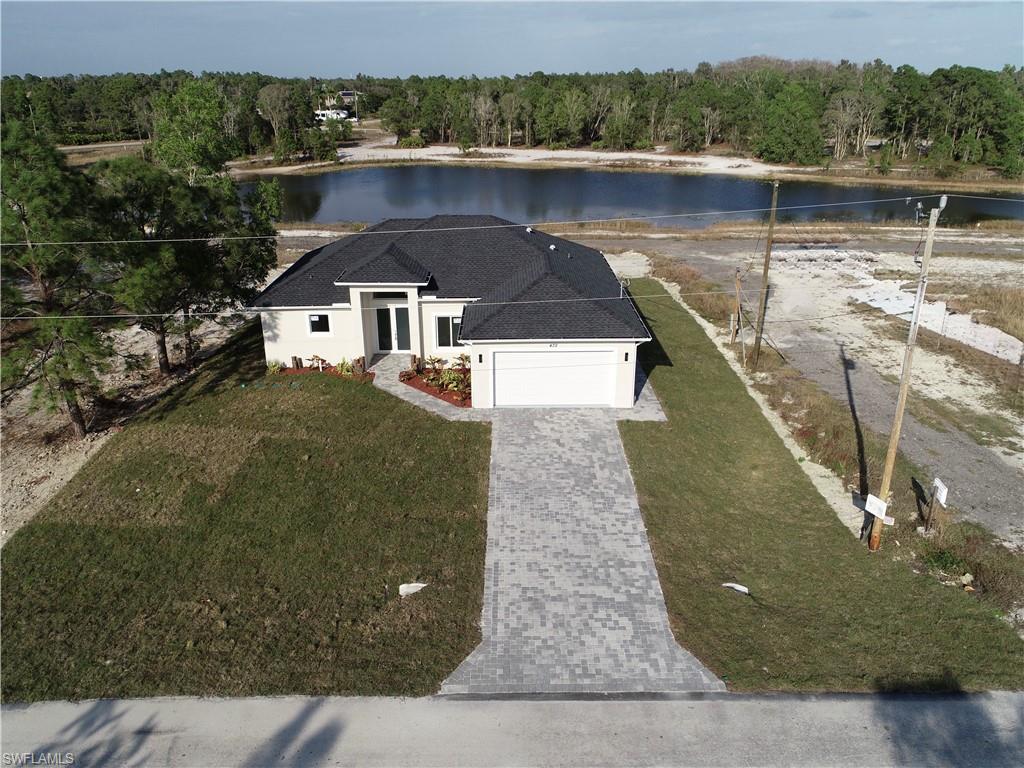 423 Harshaw Street Lehigh Acres, FL 33974 - Photo 26 of 27 an aerial view of a house with a yard