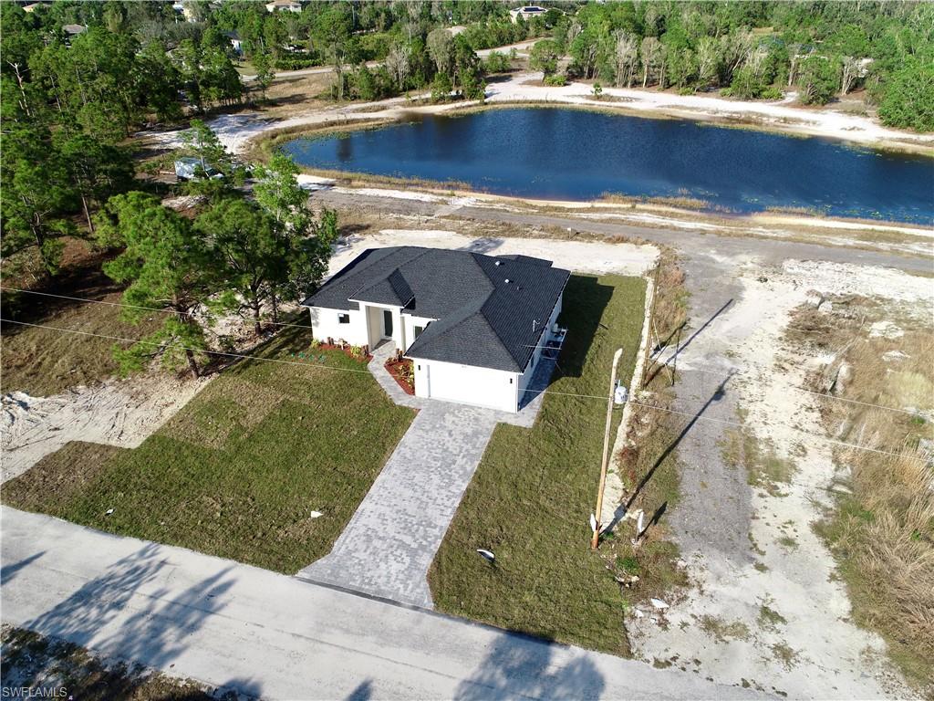 423 Harshaw Street Lehigh Acres, FL 33974 - Photo 27 of 27 a view of a swimming pool with a yard