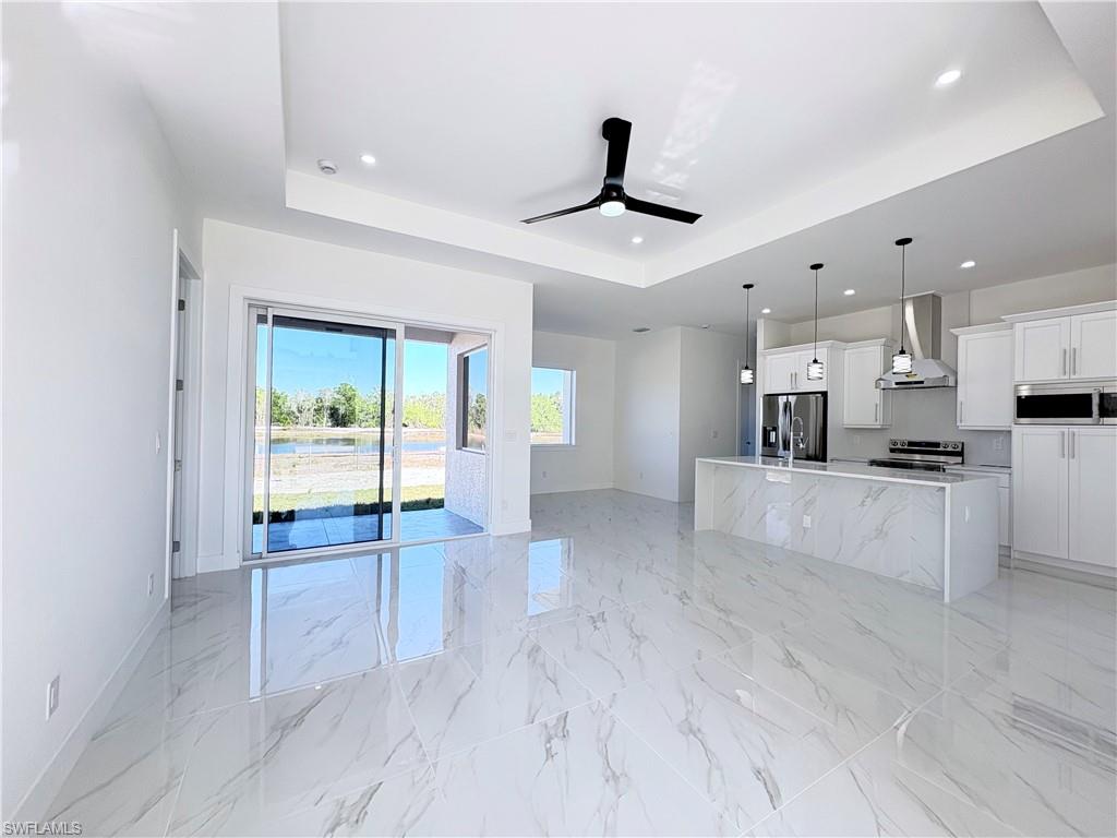 423 Harshaw Street Lehigh Acres, FL 33974 - Photo 4 of 27 a view of an empty room and kitchen view