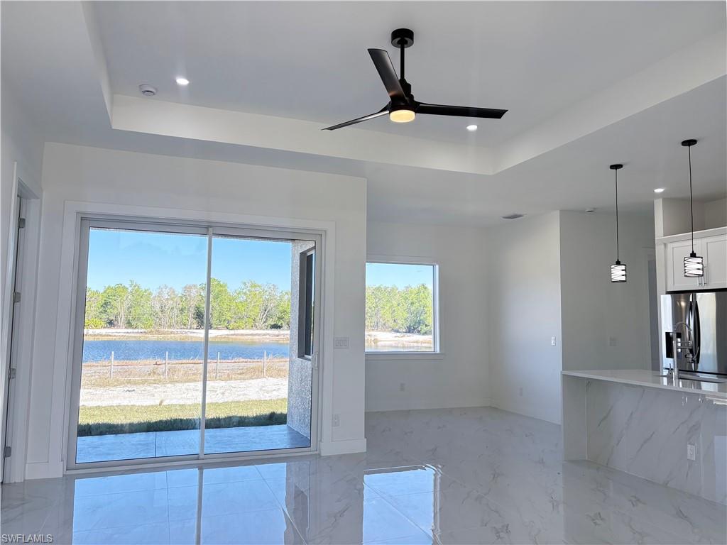 423 Harshaw Street Lehigh Acres, FL 33974 - Photo 10 of 27 a view of a livingroom with a ceiling fan and window