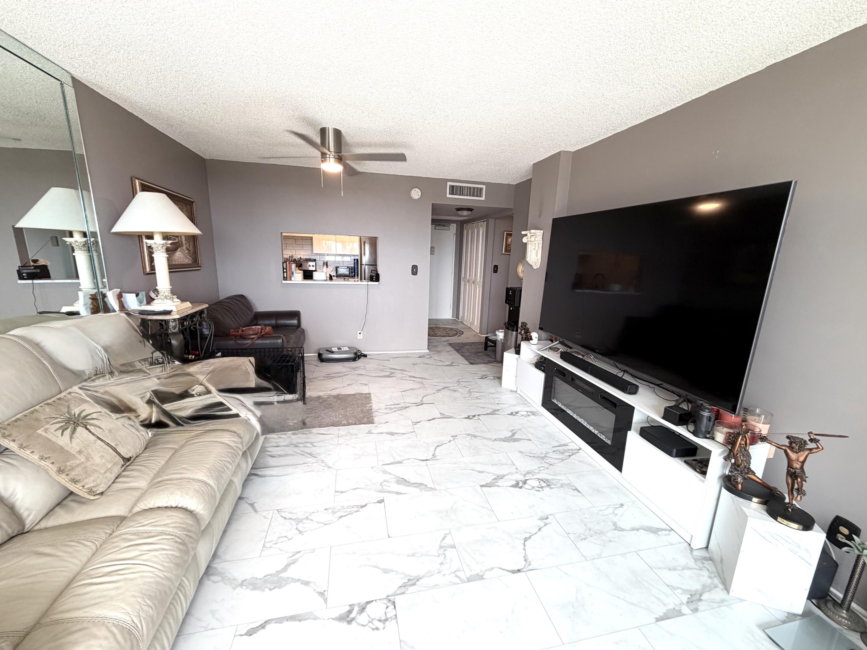 777 South Federal Highway, Unit RPH11 Pompano Beach, FL 33062 - Photo 6 of 32 a living room with furniture and a flat screen tv