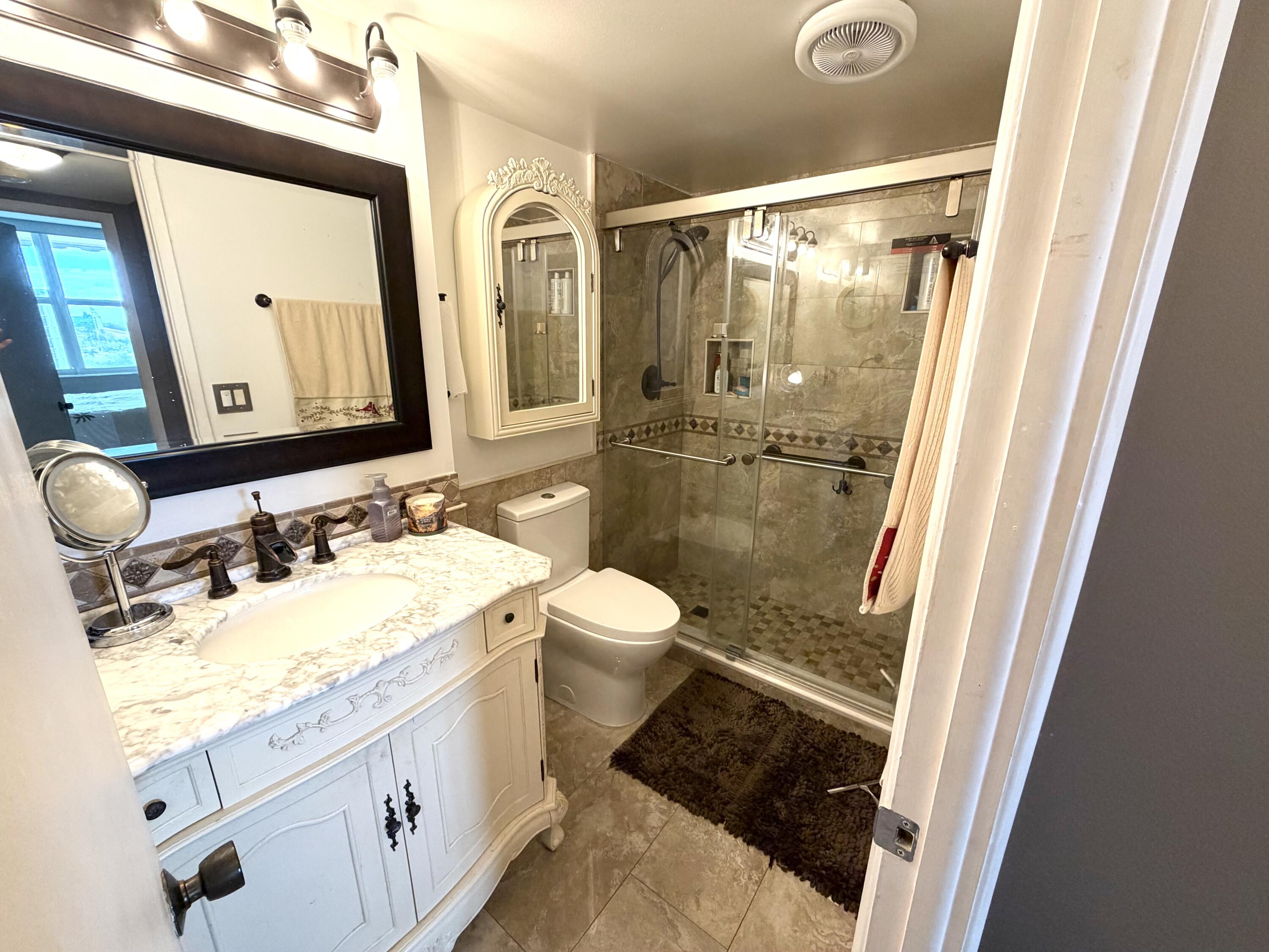 777 South Federal Highway, Unit RPH11 Pompano Beach, FL 33062 - Photo 8 of 32 a bathroom with a granite countertop sink toilet a mirror and shower