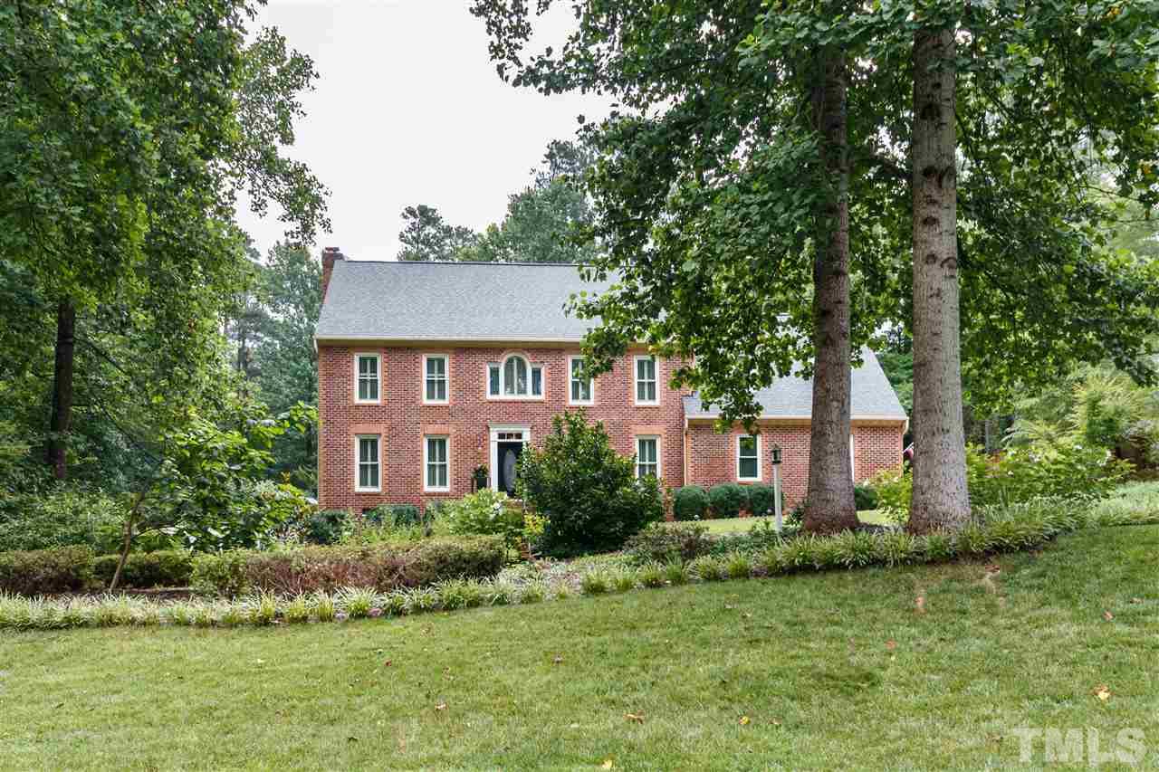 812 Misty Isle Place Raleigh, NC 27615 - Photo 1 of 25 a front view of a house with a yard and trees