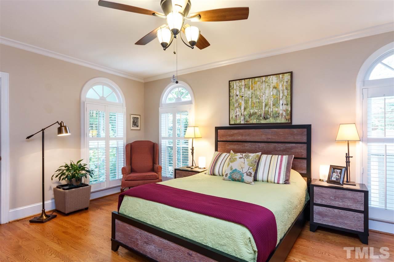 812 Misty Isle Place Raleigh, NC 27615 - Photo 13 of 25 a bedroom with a bed and a chandelier