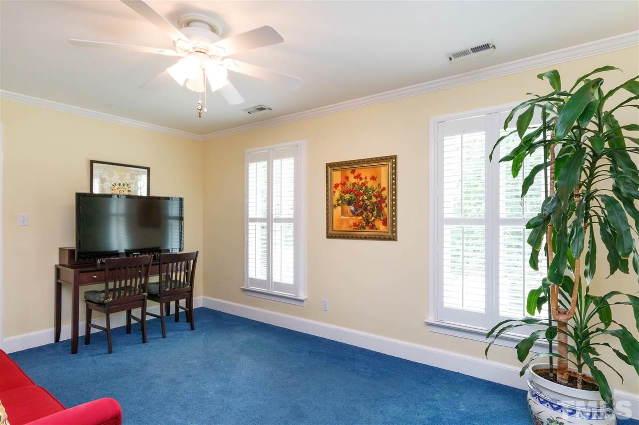 812 Misty Isle Place Raleigh, NC 27615 - Photo 16 of 25 a living room with furniture and a flat screen tv