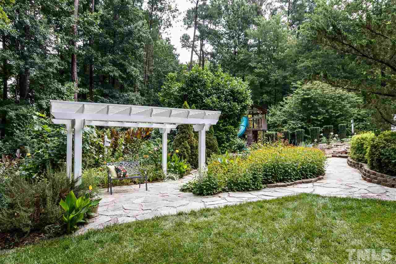 812 Misty Isle Place Raleigh, NC 27615 - Photo 21 of 25 a view of a backyard with garden