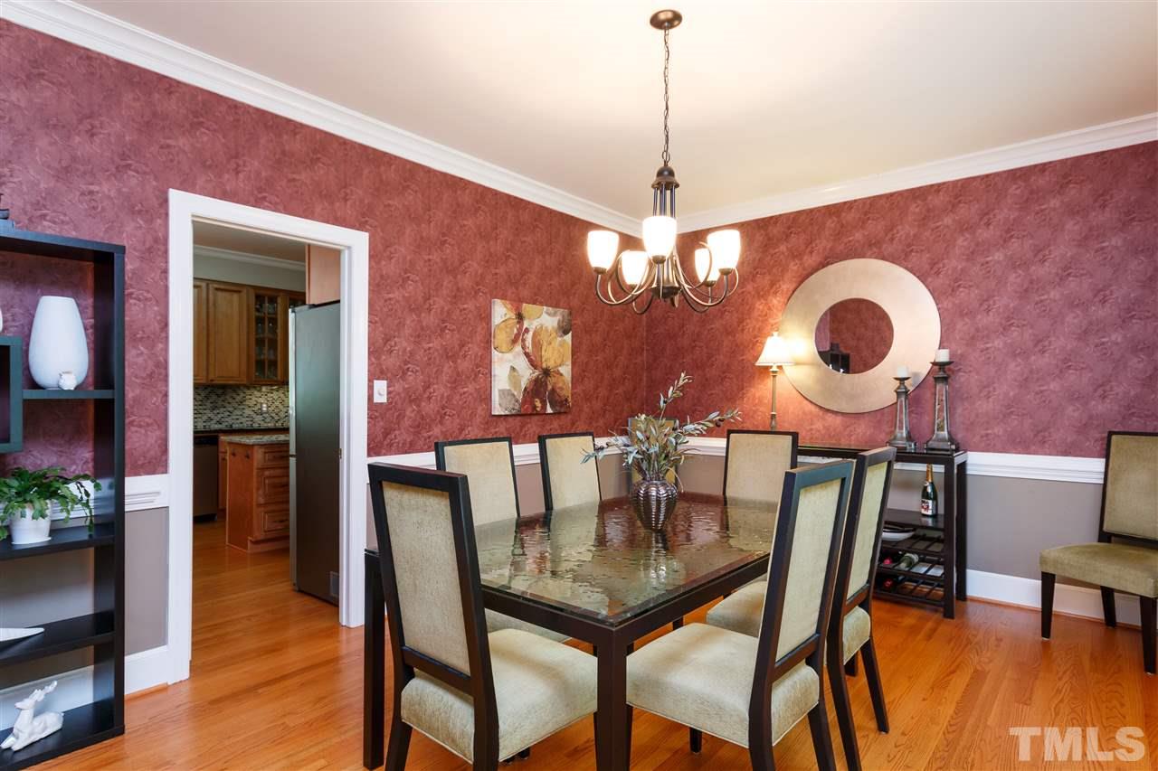 812 Misty Isle Place Raleigh, NC 27615 - Photo 5 of 25 a view of a dining room with furniture and wooden floor