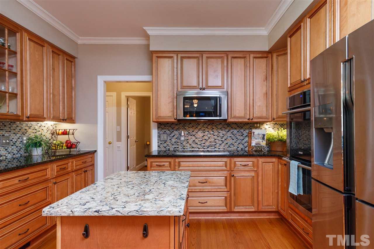 812 Misty Isle Place Raleigh, NC 27615 - Photo 6 of 25 a kitchen with stainless steel appliances granite countertop a refrigerator and microwave